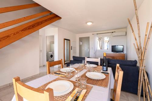 une salle à manger et un salon avec une table et des chaises dans l'établissement Prunete - Piscine - Vue mer, à Cervione