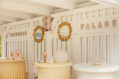 a room with two tables and two mirrors on the wall at Princess Palace in Gdańsk