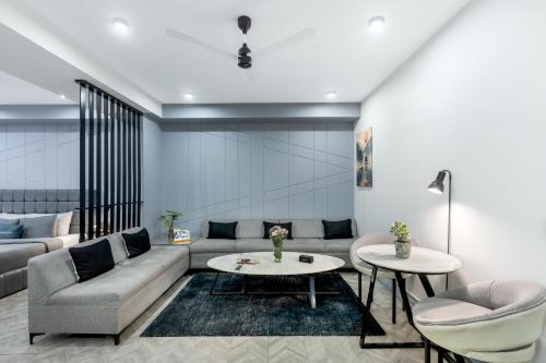 a living room with a couch and a table at BedChambers Serviced Apartments, MG ROAD in Gurgaon