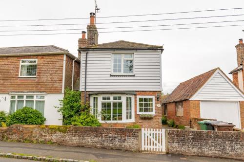a white house and two brick houses at Fern Cottage Iden, Rye in Iden