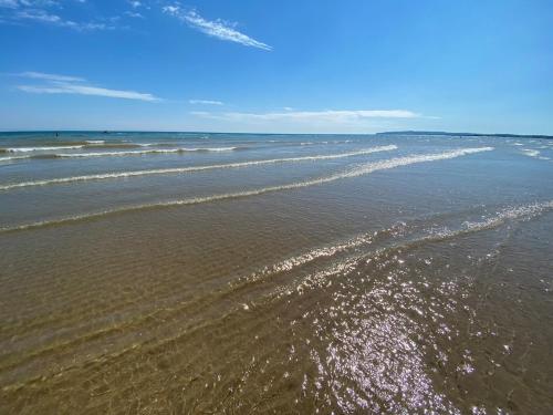 a view of a beach with waves in the water at Fern Cottage Iden, Rye in Iden