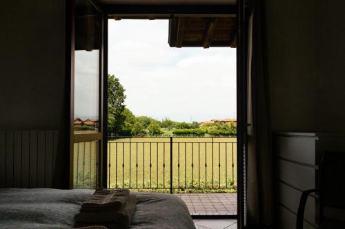 a bedroom with an open door to a balcony at Casa Oslo in Grassobbio