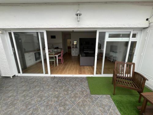 a screened in porch with a bench and a table at Sunset bungalow Oceanfront Relax in Los Realejos