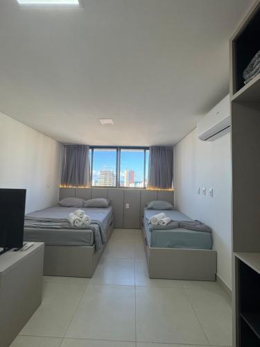 En eller flere senge i et værelse på Voll 29 Smart Flat Manaíra