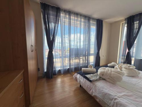 a bedroom with a bed and a large window at Sea whisper in Elenite