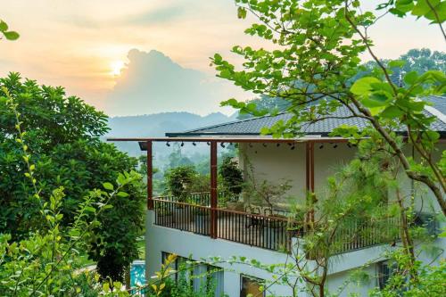 a house with a balcony with a view at Sunset Haven Villa - Venuestay in Sóc Sơn