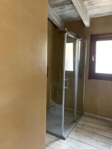 a shower in a room with a glass door at Casa Borgo Antico in Posada