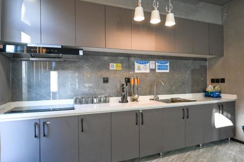 a kitchen with a sink and a counter top at Hidden Lodge Xiaoyin B&B in Xizhuang