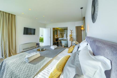 a bedroom with a large bed with pillows on it at Villa Bellevue Bast in Baška Voda