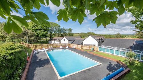 an overhead view of a swimming pool in a yard at 7 The Vista - Hot Tub - Pet Friendly in Woolacombe