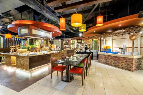 a restaurant with a table and chairs and a bar at Waterfront Cebu City Hotel & Casino in Cebu City