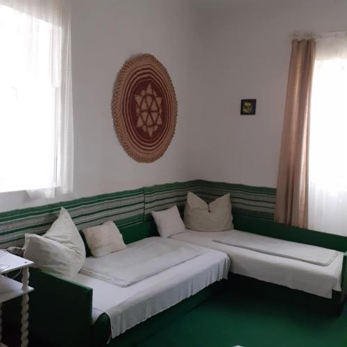 two beds in a room with green and white at Faragó Vendégház in Abádszalók
