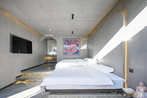 a bedroom with a large bed and a tv at Hidden Lodge Xiaoyin B&B in Xizhuang