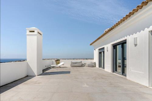 a white house with a view of the ocean at Bica Vista in Lourinhã