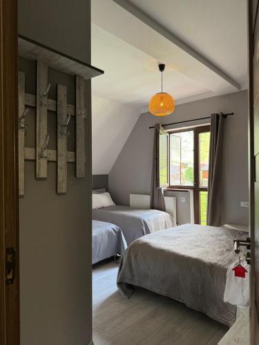 a bedroom with two beds and a window at OISHE Boutique Hotel in Stepantsminda