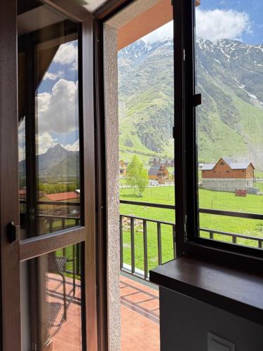 a view from a door looking out at a mountain at OISHE Boutique Hotel in Stepantsminda