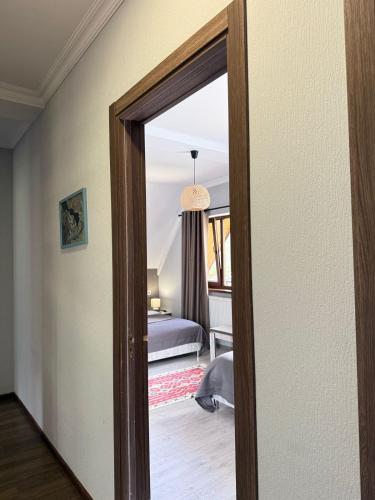 a door leading into a bedroom with a bed at OISHE Boutique Hotel in Stepantsminda