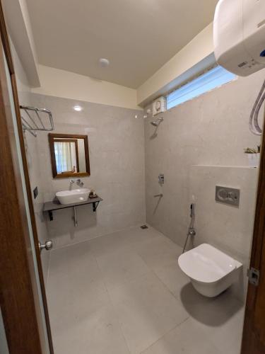 a bathroom with a toilet and a sink at GG in Imphal