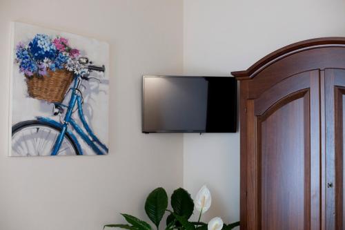 a blue bike hanging on a wall with a television at Casale San Galgano in Chiusdino