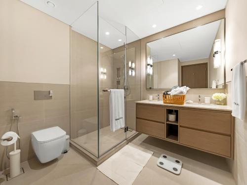 a bathroom with a shower and a toilet and a sink at SmartStay at Grande Signature - Downtown Dubai City Views - Brand New Luxury Apartments in Dubai