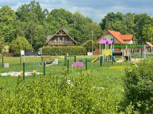 a park with a playground in the grass at Apartament Zielona in Mysłakowice