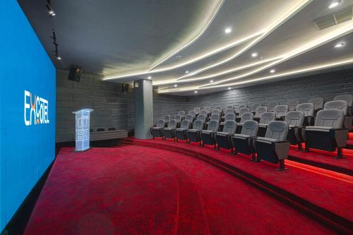 a theater with chairs and a red carpet in a room at EXCOTEL Design Hotel Surabaya in Surabaya