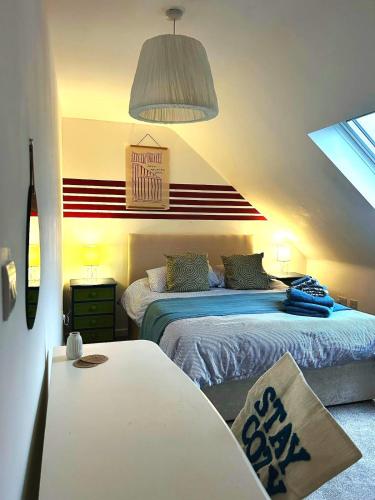 a bedroom with two beds and a table in it at 8 - Mouse Hole, Norfolk in Sparham