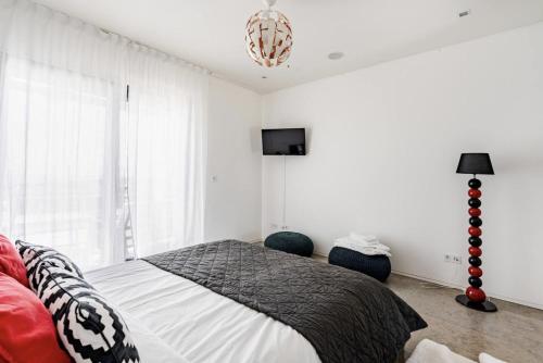 a bedroom with a bed and a television in it at Bica Vista in Lourinhã