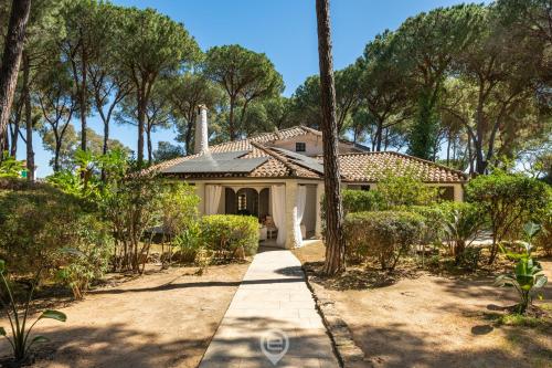 a house with trees and a driveway at Villa Scano in Fort Village