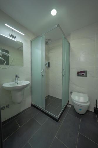 a bathroom with a shower and a toilet and a sink at Diamond Hotel in Istanbul