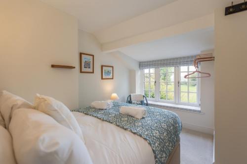 a bedroom with a bed with two pillows on it at Robins Cottage in York