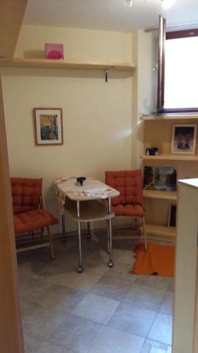 a living room with a table and two chairs at ANERI in Ljubljana