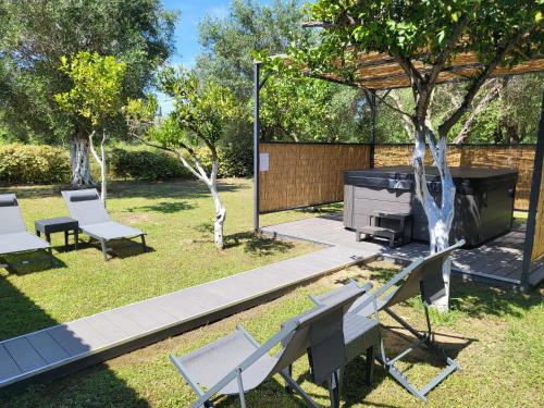 a backyard with a grill and chairs and a piano at EMA Spa The Red house in Potámion