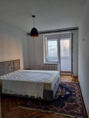 a bedroom with a bed and a large window at House of Westeros - OldTown in Chişinău