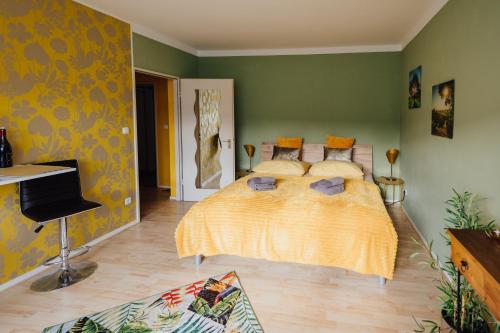 a bedroom with a bed in a room with green walls at Keksfabrik Lofts zentral in Hamburg in Hamburg