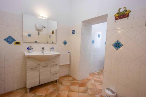 a bathroom with a sink and a shower at Ambra - Luxury & Big Apartment with Garden & Pool in Casamassella