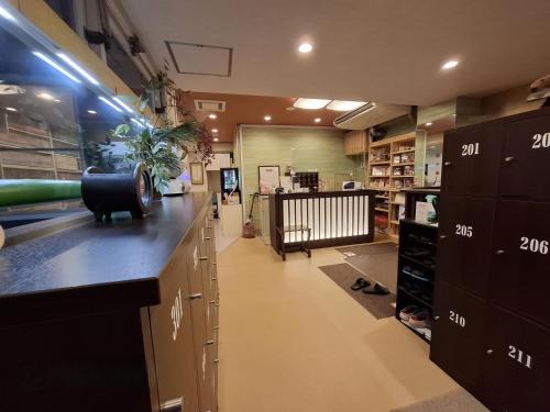 a large room with a counter and cabinets in a store at Business Ryokan Akashiya Annex in Akashi