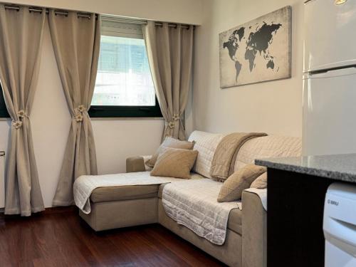 a living room with a couch and a window at Rei Túzaro in Milladoiro