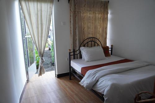 a bedroom with a bed and a window at New Dream House in Arusha