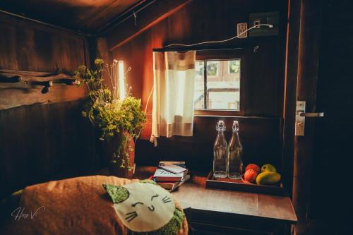 a room with a bed with a cat pillow and a window at Đến Nơi Có Gió - Homestay And Coffee in Hữu Lũng