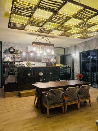 a dining room with a table and some chairs at Wonderland Hồ Tràm - Mocha Viva in Ho Tram