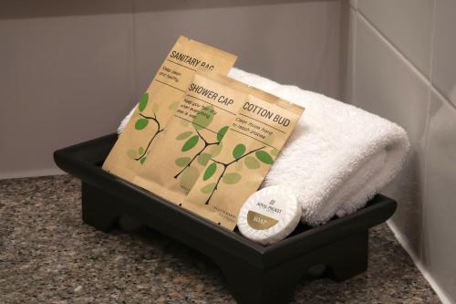 a box and a towel and a roll of paper at Royal Phuket City Hotel in Phuket Town