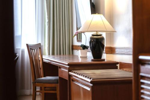 a lamp sitting on a desk in a hotel room at Royal Phuket City Hotel in Phuket Town