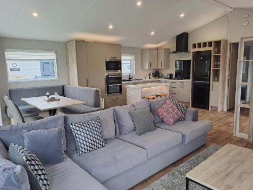 a living room with a couch and a kitchen at North Shore Holiday Park, Skegness in Winthorpe