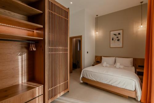 a bedroom with a bed and a large closet at Sarana Suites Crete in Kissamos