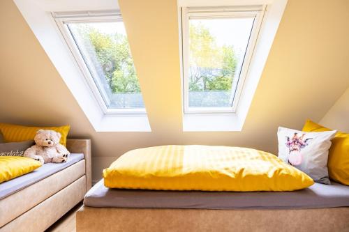 a bedroom with two beds and a teddy bear at Haus Amore-Familienidyll am See in Neubrandenburg