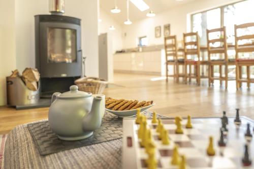 a chess board and a tea pot sitting on a table next to a chess game at The Neuk in Kincraig