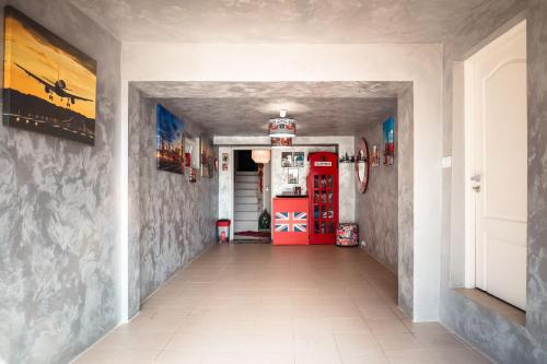 a hallway with a red door in a house at Princess Palace in Gdańsk