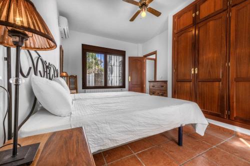 a bedroom with a bed and a ceiling fan at Casa del Molino in Canillas de Aceituno