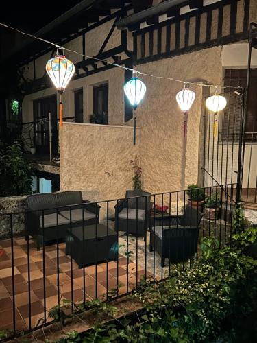 a patio with chairs and lights on a fence at El Rincón Templario in La Alberca